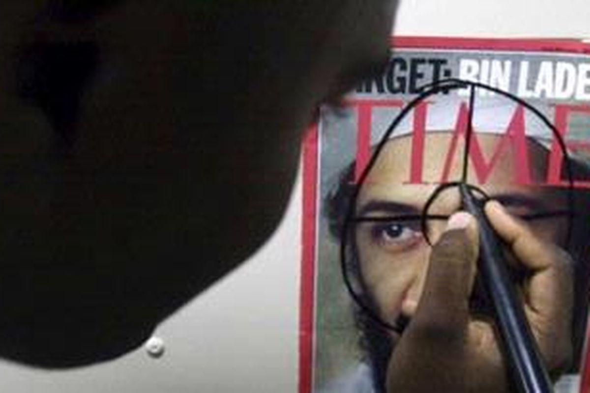 U.S. Special Operation Capable (SOC) Marine SSGT Rodric Green from Corsicana, Texas, with the 26th Marines Expeditionary Unit (MEU), draws a target on a picture of Osama bin Laden before the start of an urban combat and room clearing exercise aboard the USS Whidbey Island, off the coast of Pakistan, December 12, 2001. Al Qaeda leader Osama bin Laden was killed on May 1, 2011 in a firefight with U.S. forces in Pakistan, ending a years-long hunt for the mastermind behind the 2001 attacks on New York and Washington. U.S. President Barack Obama announced the news in a speech and said that bin Ladens body had been recovered following the U.S.-led operation near Islamabad. Picture taken December 12, 2001.