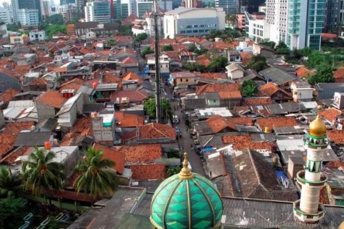 Permukiman padat penduduk yang dikelilingi gedung bertingkat di Kuningan, Jakarta Selatan, Minggu (12/5/2013).