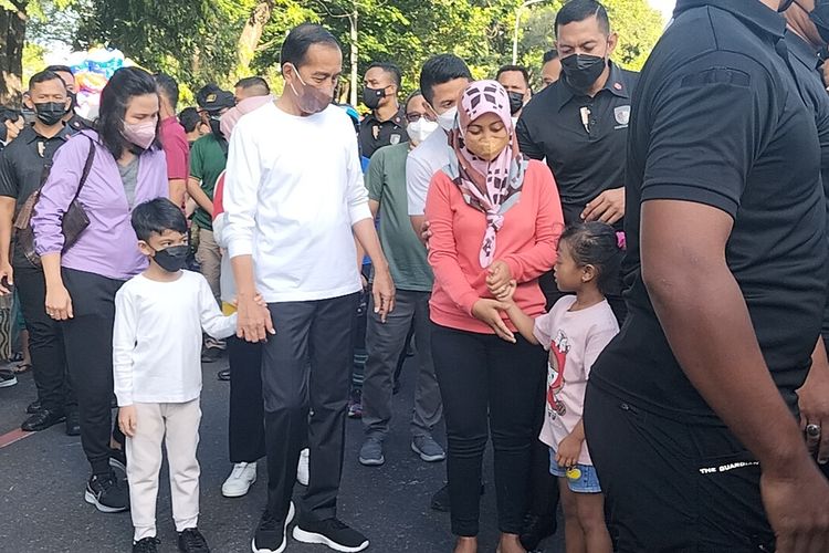 Presiden Joko Widodo (Jokowi) bersama cucu pertamanya Jan Ethes Srinarendra dan Ibu Negara Iriana Jokowi berolahraga dan menyapa warga di Car Free Day (CFD) Kota Solo, Jawa Tengah, Minggu (7/8/2022).