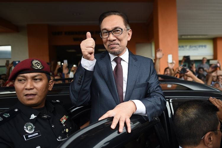 Mantan pemimpin oposisi Malaysia Anwar Ibrahim mengacungkan ibu jari ke arah para pendukungnya saat meninggalkan RS Cheras, Kuala Lumpur, Rabu (16/5/2018).
