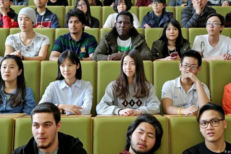Students from many countries, including those from Asia, sit at a lecture hall at a university in Zwickau, Saxony