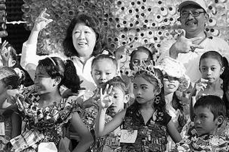 Menteri Pariwisata dan Ekonomi Kreatif Mari Elka Pangestu (belakang kiri) berfoto bersama anak-anak Labuan Bajo, Kabupaten Manggarai Barat, Nusa Tenggara Timur, Senin (4/8/2014). Anak-anak ini mengenakan busana dari barang yang tidak terpakai yang mereka kreasikan sendiri.