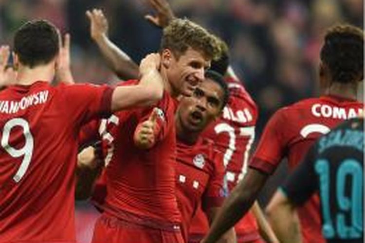 (Kiri ke kanan) Striker Bayern Muenchen Robert Lewandowski, Thomas Mueller dan gelandang Douglas Costa melakukan selebrasi setelah Mueller mencetak gol kedua ke gawang Arsenal pada lanjutan penyisihan Grup F Liga Champions di Allianz Arena, Rabu (4/11/2015).