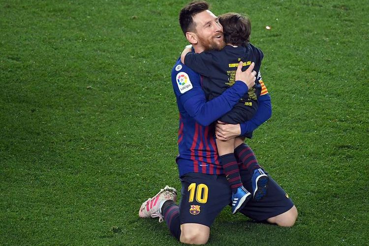 Pemain Barcelona Lionel Messi memeluk putranya usai timnya berhasil mengalahkan Levante dalam lanjutan La Liga di Stadion Camp Nou, Sabtu (27/4/2019) atau Minggu dini hari Wib. Gol tunggal Lionel Messi pada laga tersebut memastikan Barcelona unggul 1-0 atas Levante dan berhak keluar sebagai juara Liga Spanyol 2018/2019.