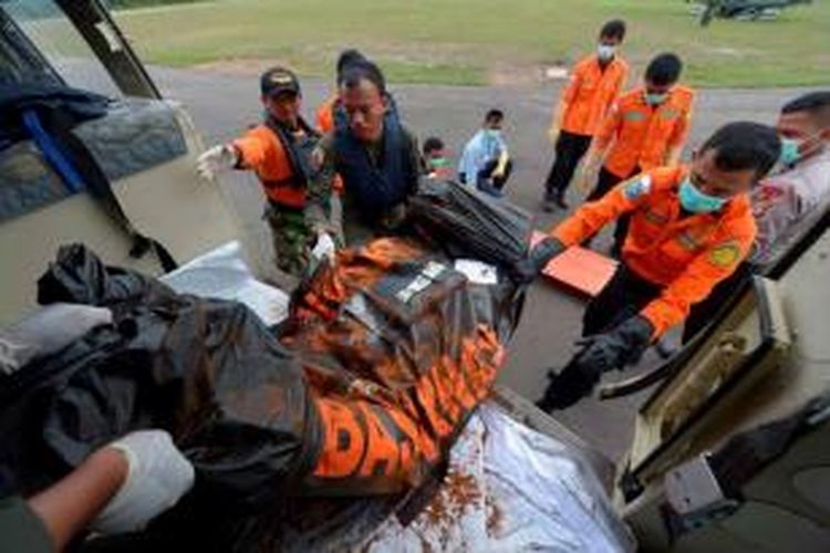 Anggota Basarnas menurunkan jenazah korban jatuhnya pesawat AirAsia QZ8501 dari helikopter Bell-420 yang membawanya dari KRI Banda Aceh di Laut Jawa dekat perairan Pangkalan Bun, Kalimantan Tengah, Sabtu (3/1/2015).