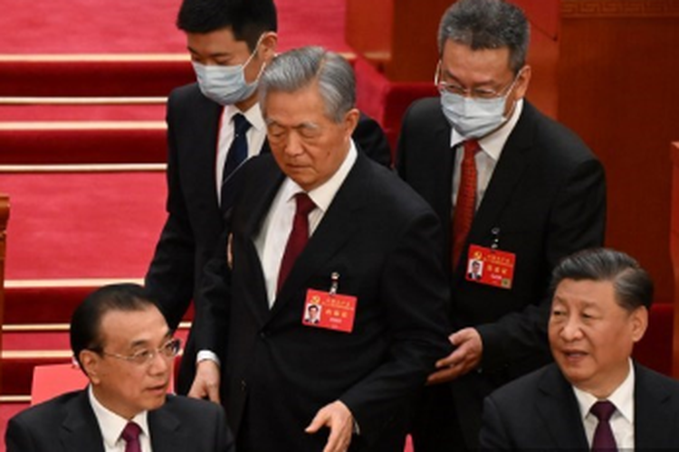 Presiden China Xi Jinping (kanan) duduk di samping Perdana Menteri Li Keqiang (kiri) saat mantan presiden China Hu Jintao (tengah) dibantu untuk pergi dari upacara penutupan Kongres Partai Komunis China ke-20 di Aula Besar Rakyat di Beijing pada Sabtu (22/10/2022). 