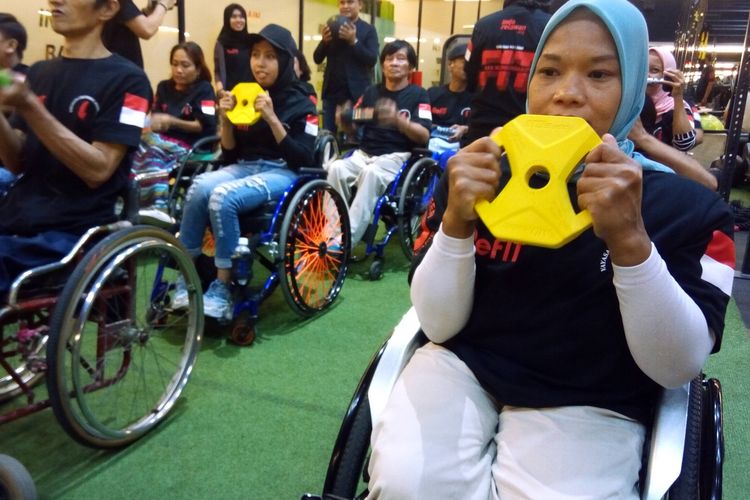 Seorang penyandang disabilitas menggunakan dumble untuk melatih otot pada Kamis (5/12/2019) di ReFIT Club SS72 Jalan Sepat Kebagusan Jakarta. 

