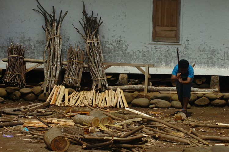 Foto dirilis Rabu (30/1/2019), menunjukkan warga memotong kayu bakar untuk persedian bahan bakar memasak di Kampung Naga, Kabupaten Tasikmalaya, Jawa Barat. Warga Kampung Naga merupakan salah satu masyarakat adat yang masih memegang tradisi nenek moyang mereka, salah satunya adalah tradisi panen padi.