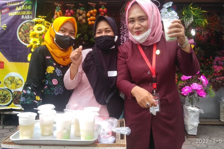 Anggota DPRD Kabupaten Grobogan Lusia Indah Artani menjajal es gempol dagangan Suwarni (47) di Pasar Umum Kota Purwodadi, Grobogan, Rabu (5/1/2022).