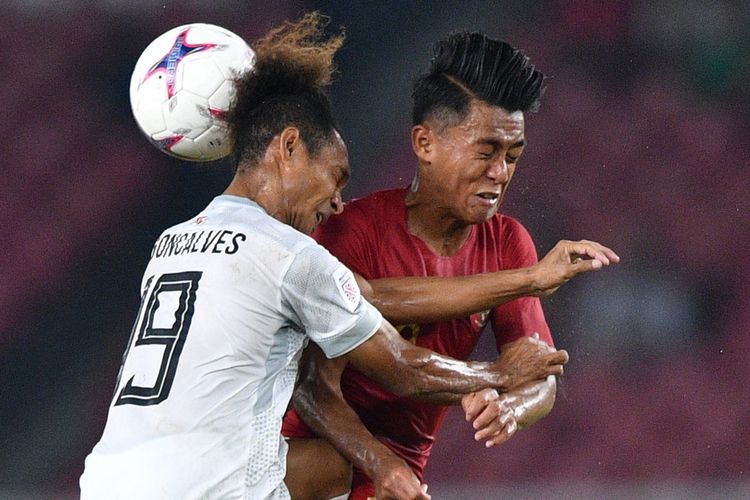 Pemain timnas Indonesia Febri Hariyadi berebut bola di udara dengan pemain timnas Timor Leste Feliciano Pinheiro Goncalves  dalam penyisihan grub B Piala AFF 2018 di Stadion Utama Gelora Bung Karno, Jakarta, Selasa (13/11/2018).  