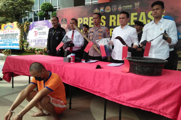 Polisi menunjukkan barang bukti berikut pelaku (duduk depan), saat rilis ungkap kasus di halaman kantor Polres Gresik, Jawa Timur, Senin (3/7/2023).