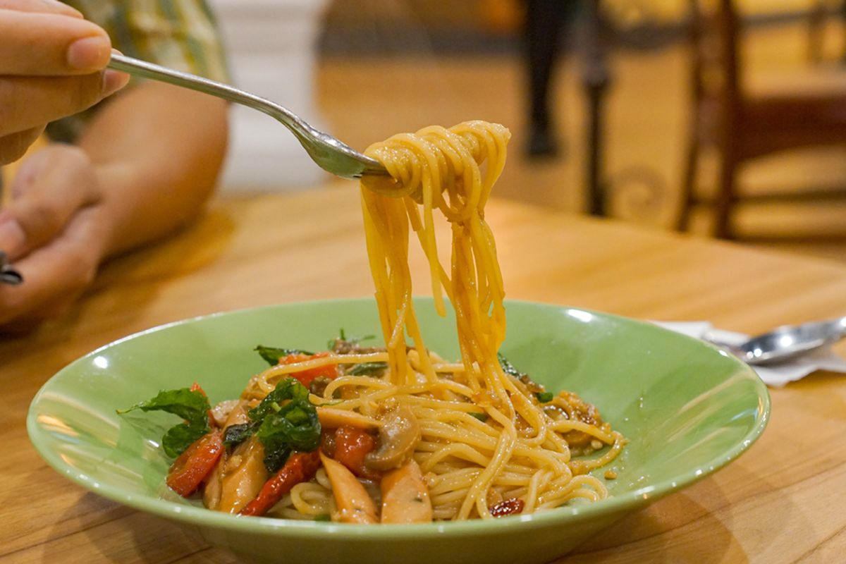 Stir-Fried Spaghetti with Olive Oil, Garlic , Dried Chili And Crispy Bacon, hand hold the fork roll spagetti