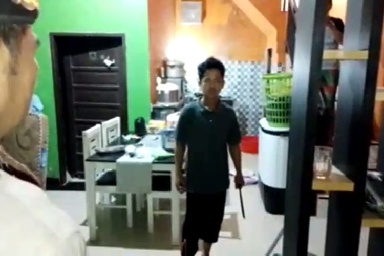Salah satu anak tergugat melakukan perlawanan dengan menenteng sebilah pisau saat eksekusi rumah digelar oleh Pengadilan Negeri Sungguminasa, Kabupaten Gowa Sulawesi, Selatan. Rabu, (8/3/2023).