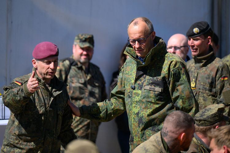 Kanselir Jerman Friedrich Merz (kanan) saat berbicara dengan salah satu tentara dalam kunjungan ke barak militer di Munster, Jerman utara, 30 April 2026.