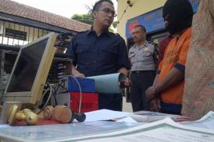 Kasatreskrim Polres Malang AKP Wahyu Hidayat (kiri) dan tersangka pemalsu akta kelahiran dan akta cerai yang berhasil dibekuk polisi. Jumat (6/6/2014).