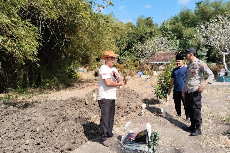 Polisi dan kepala desa saat melihat kondisi makam yang terbongkar, Sabtu (29/6/2024)