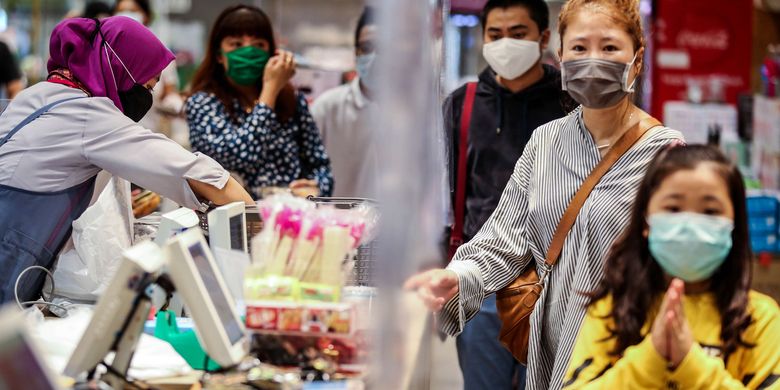 Pembeli menggunakan masker saat melakukan pembayaran dari balik plastik pembatas di supermarket AEON Mal Serpong, Tangerang, Banten, Selasa (26/5/2020).  Pemerintah Indonesia bersiap menerapkan tatanan baru (new normal) dalam waktu dekat. Salah satunya dengan mulai membuka pusat perbelanjaan secara bertahap di bulan Juni mendatang.