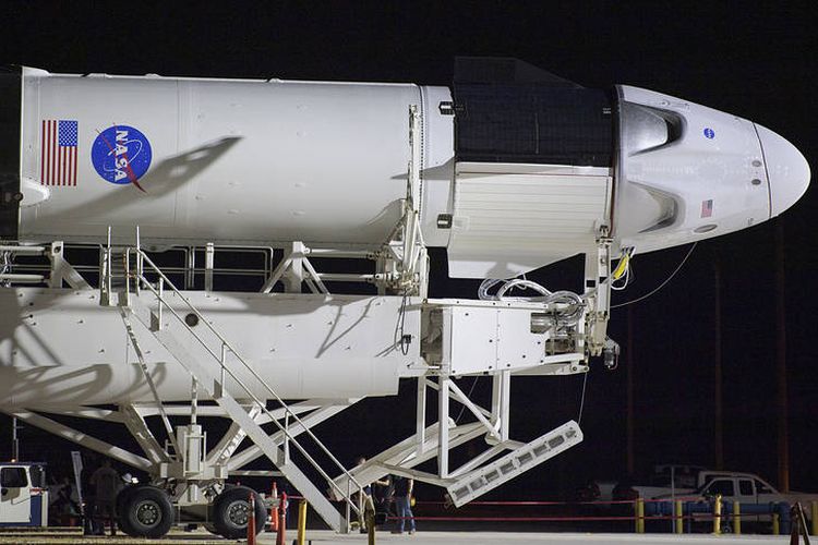 A SpaceX Falcon 9 rocket with the company's Crew Dragon spacecraft onboard is seen as it is rolled out of the horizontal integration facility at Launch Complex 39A as preparations continue for the Demo-2 mission, Thursday, May 21, 2020, at NASA?s Kennedy Space Center in Florida. NASA?s SpaceX Demo-2 mission is the first launch with astronauts of the SpaceX Crew Dragon spacecraft and Falcon 9 rocket to the International Space Station as part of the agency?s Commercial Crew Program. The flight test will serve as an end-to-end demonstration of SpaceX?s crew transportation system. Behnken and Hurley are scheduled to launch at 4:33 p.m. EDT on Wednesday, May 27, from Launch Complex 39A at the Kennedy Space Center. A new era of human spaceflight is set to begin as American astronauts once again launch on an American rocket from American soil to low-Earth orbit for the first time since the conclusion of the Space Shuttle Program in 2011. Photo Credit: (NASA/Bill Ingalls)