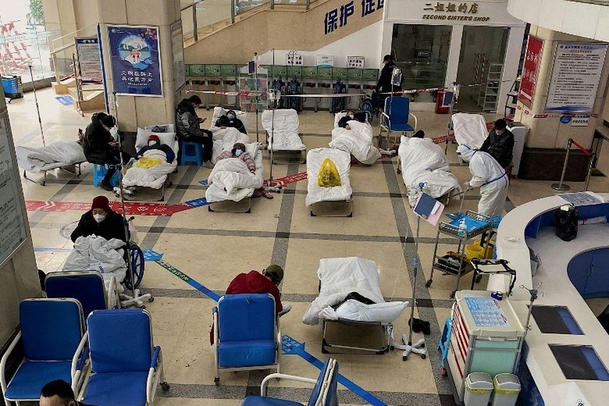 Seorang pria berdiri di depan area tertutup, tempat pasien virus corona Covid-19 terbaring di ranjang rumah sakit, di lobi Rumah Sakit Rakyat No. 5 Chongqing di kota Chongqing di barat daya China pada 23 Desember 2022.