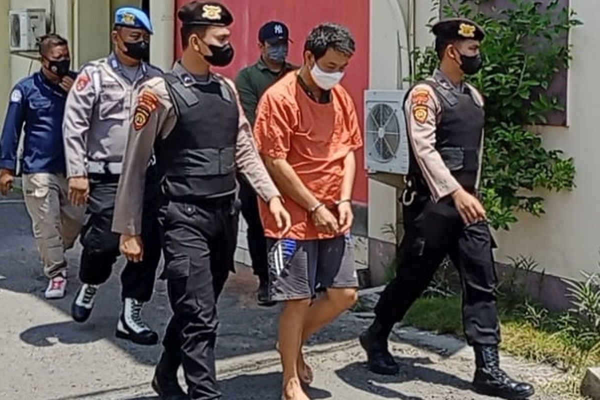 Daud Patriono Imanuel (52) saat menuju ruang tahanan Polres Probolinggo, Jawa Timur, setelah resmi menjadi tersangka akibat tembakan yang menewaskan karyawannya, Sabtu (9/4/2022)