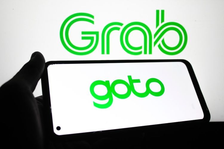 Ilustrasi isu merger Grab dan GoTo.