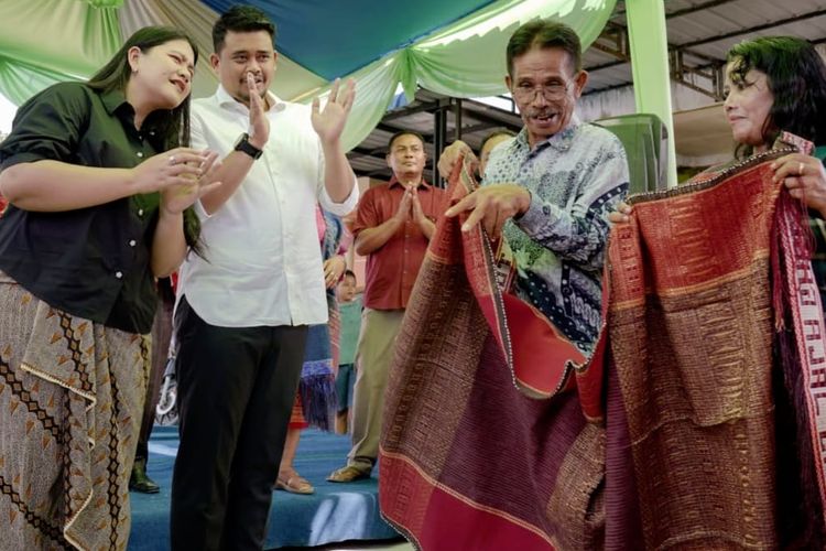 Warga Cinta Damai mengulosi Wali Kota Medan Bobby Nasution dan istrinya Kahiyang Ayu karena telah membuka akses jalan yang mereka keluhkan sejak 30 tahun lalu, Sabtu (19/11/2022). 