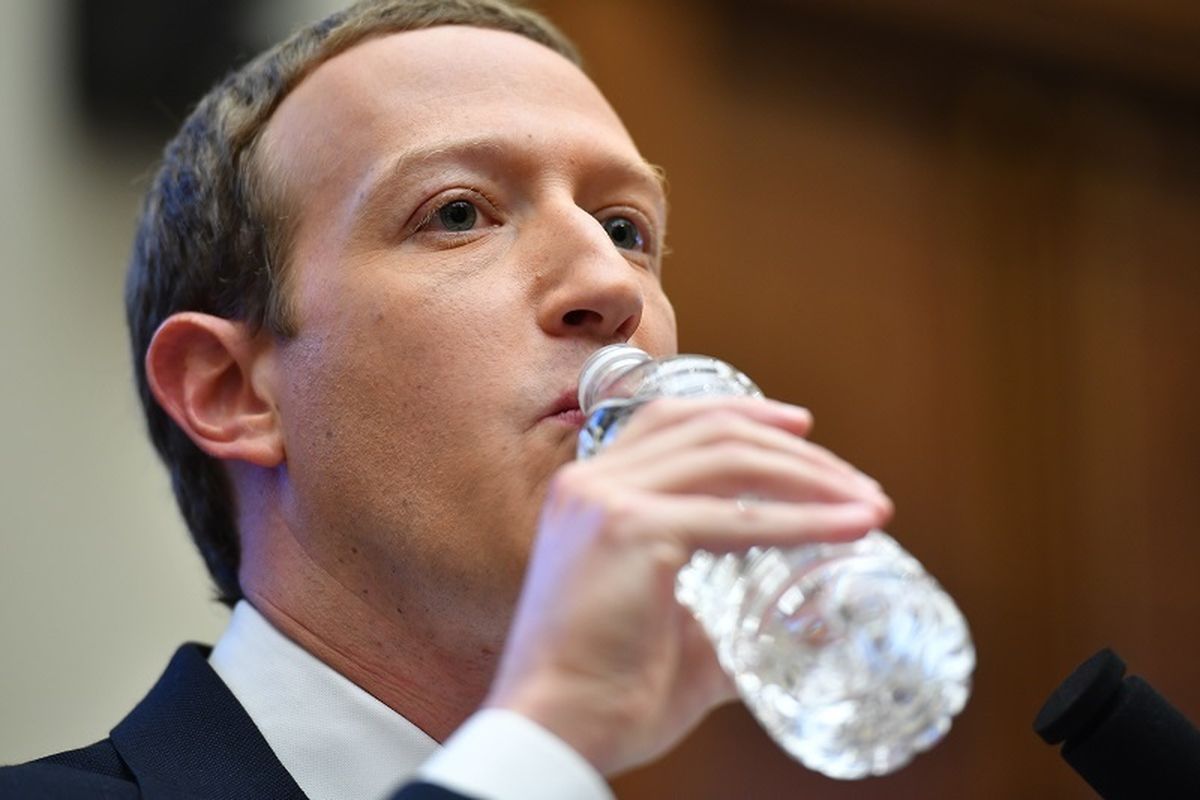 CEO Facebook, Mark Zuckerberg meminum air di sela-sela sidang dengar pendapat di Komite Jasa Keuangan pada bulan Oktober 2019. 