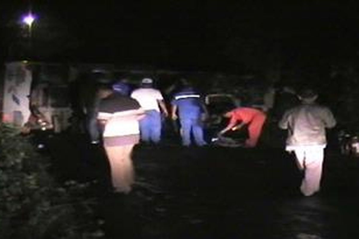 Petugas dari Pertamina Depo Camplong, Sampang, saat memindahkan premium yang tersisa dari tanki