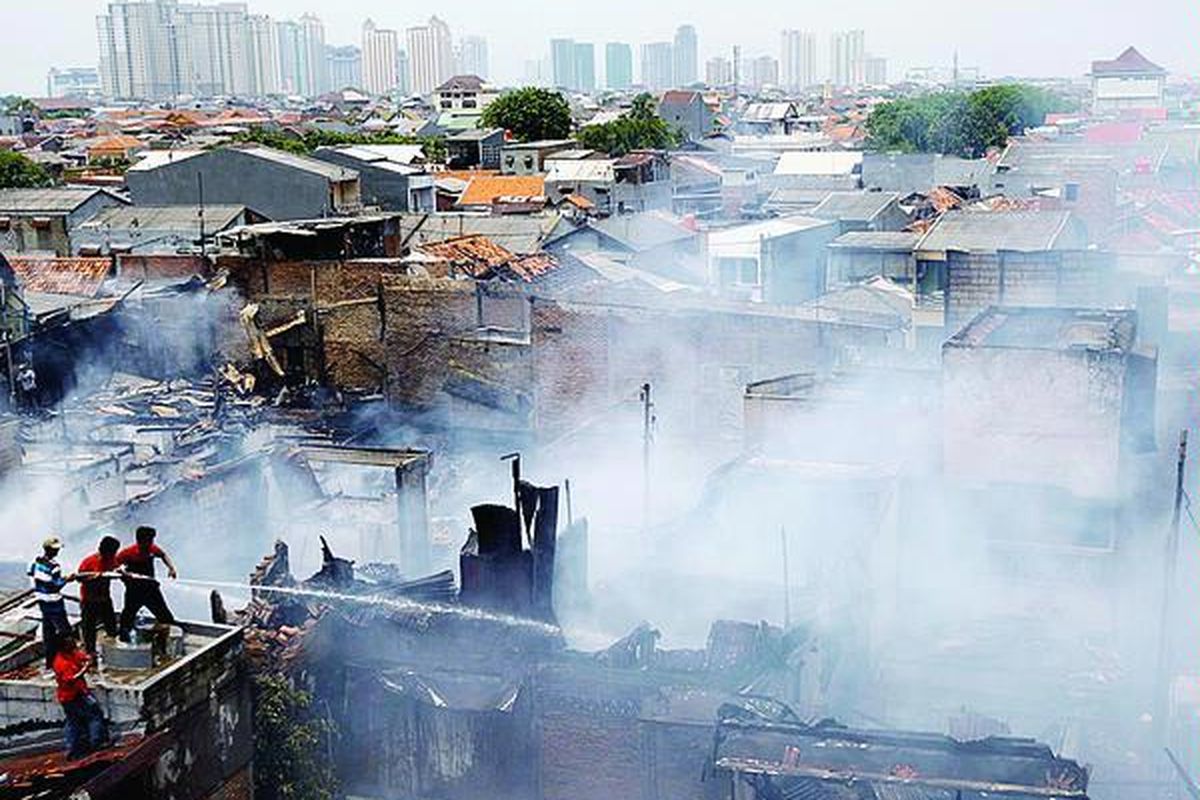 Warga membantu petugas  memadamkan api yang  membakar rumah-rumah warga di Kelurahan Cempaka Baru, Kemayoran, Jakata Pusat, Kamis (1/11). Kebakaran yang meludeskan 86 unit rumah tersebut membuat 650 warga kehilangan tempat tinggal.