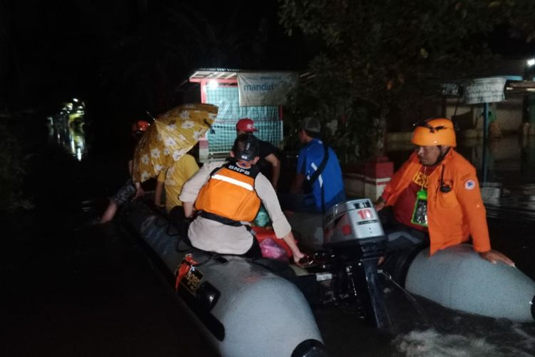 Relawan BPBD mengevakuasi warga terdampak banjir di Kabupaten Banyumas, Jawa Tengah, Selasa (22/3/2022) malam.