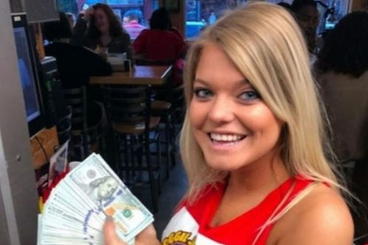 Pramusaji restoran, Alaina Custer menunjukkan tumpukan uang tip senilai 10.000 dolar yang ditinggalkan YouTuber di mejanya.