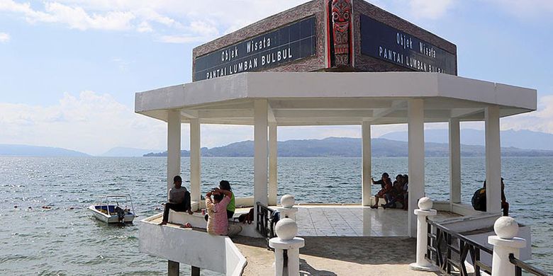 Wisatawan menikmati Danau Toba di Pantai Pasir Putih Lumban Bulbul, Kecamatan Balige, Kabupaten Toba Samosir, Sumatera Utara, Jumat (9/6/2017).