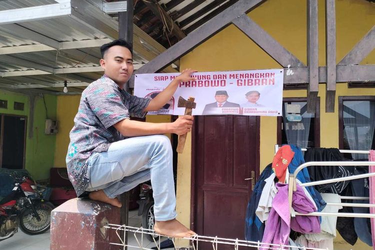 Salah seorang warga di Kecamatan Nagreg, Kabupaten Bandung, Jawa Barat tengah memasang banner Prabowo dan Gibran usai diresmikan pada Minggu (22/10/2023) kemarin