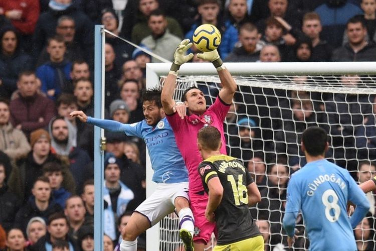 Alex McCarthy bergerak lebih cepat daripada David Silva pada pertandingan Manchester City vs Southampton dalam lanjutan Liga Inggris di Stadion Etihad, 2 November 2019. 