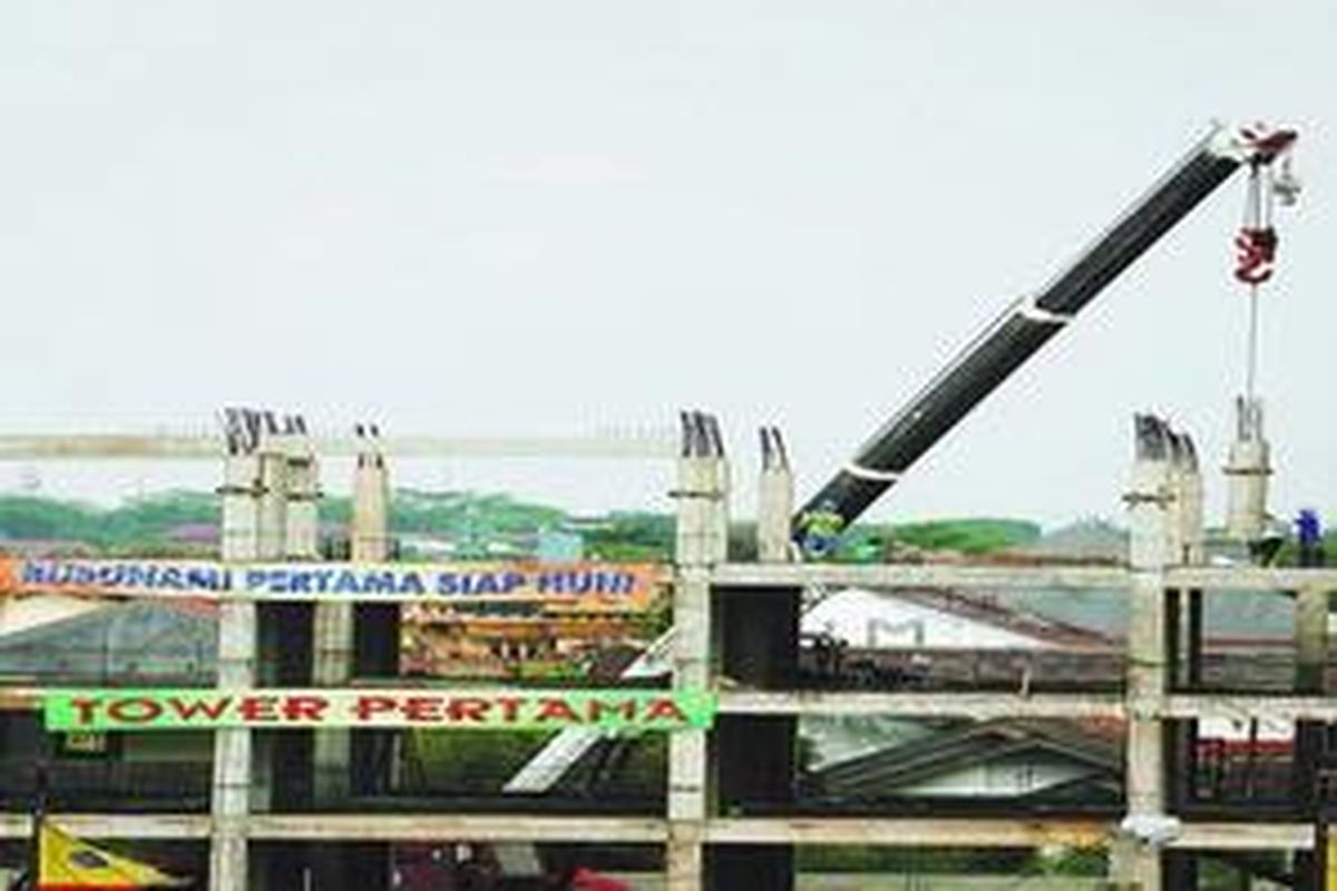 Pekerja merampungkan pembangunan rumah susun sederhana milik (rusunami) yang disubsidi pemerintah di kawasan Pulo Gebang, Jakarta, Minggu (15/6). Sejumlah pengembang mengusulkan kenaikan harga rusunami sebesar 15-25 persen dari harga jual Rp 144 juta per unit. Hal ini dilakukan untuk mengimbangi kenaikan harga-harga bahan bangunan.