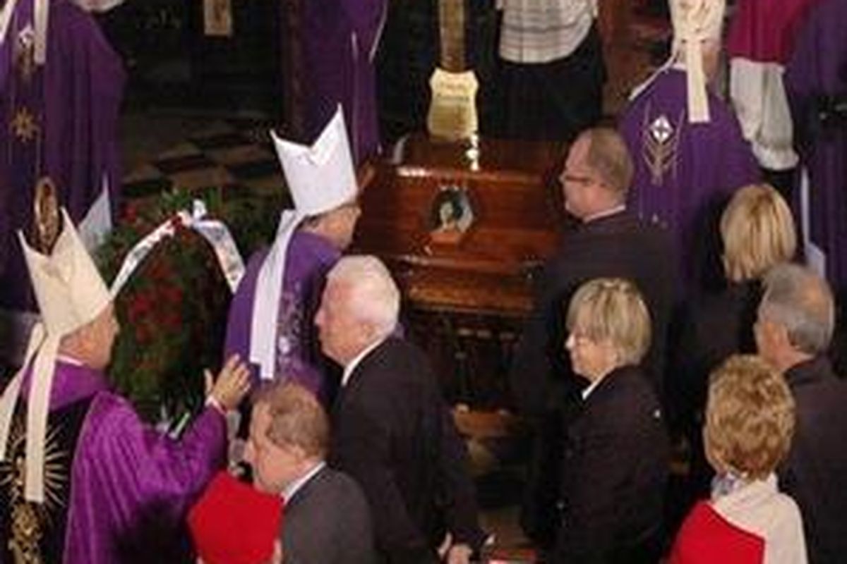 People and priests gather beside the coffin with the remains of astronomer Nicolaus Copernicus, in the catherdral in Frombork, northern Poland, Saturday, May 22, 2010. Copernicus, the 16th-century astronomer whose findings were condemned by the Roman Catholic Church as heretical, was reburied by Polish priests as a hero on Saturday, nearly 500 years after he was laid to rest in an unmarked grave. 
