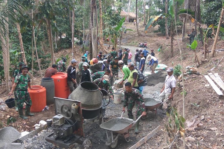 Prajurit TNI gotong royong bersama warga membangun jalan di Desa Parakanmanggu, Kecamatan Parigi, Kabupaten Pangandaran, Kamis (3/10/2019).
