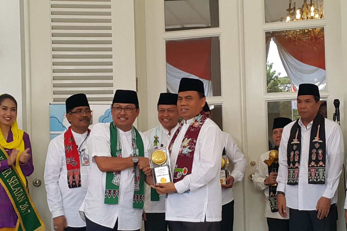 Wali Kota Jakarta Selatan Tri Kurniadi (kiri) menyerahkan Piala Adipura kepada Sekretaris Daerah DKI Jakarta Saefullah (kanan) di Balai Kota DKI Jakarta, Kamis (3/8/2017).