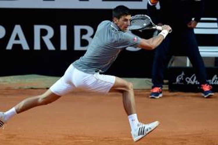 Petenis Serbia, Novak Djokovic, mengembalikan bola dari pemain Brasil, Thomaz Bellucci, pada babak ketiga Roma Masters, Kamis (14/5/2015). Djokovic menang 5-7, 6-2, 6-3.