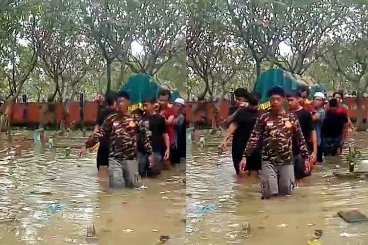 Warga di Dusun/Desa Driyorejo, Kecamatan Driyorejo, Gresik, Jawa Timur, menggelar pemakaman di tengah kondisi banjir, Selasa (25/2/2025) siang. Jenazah Martawi, warga setempat, dimakamkan setelah ibadah salat zuhur. 