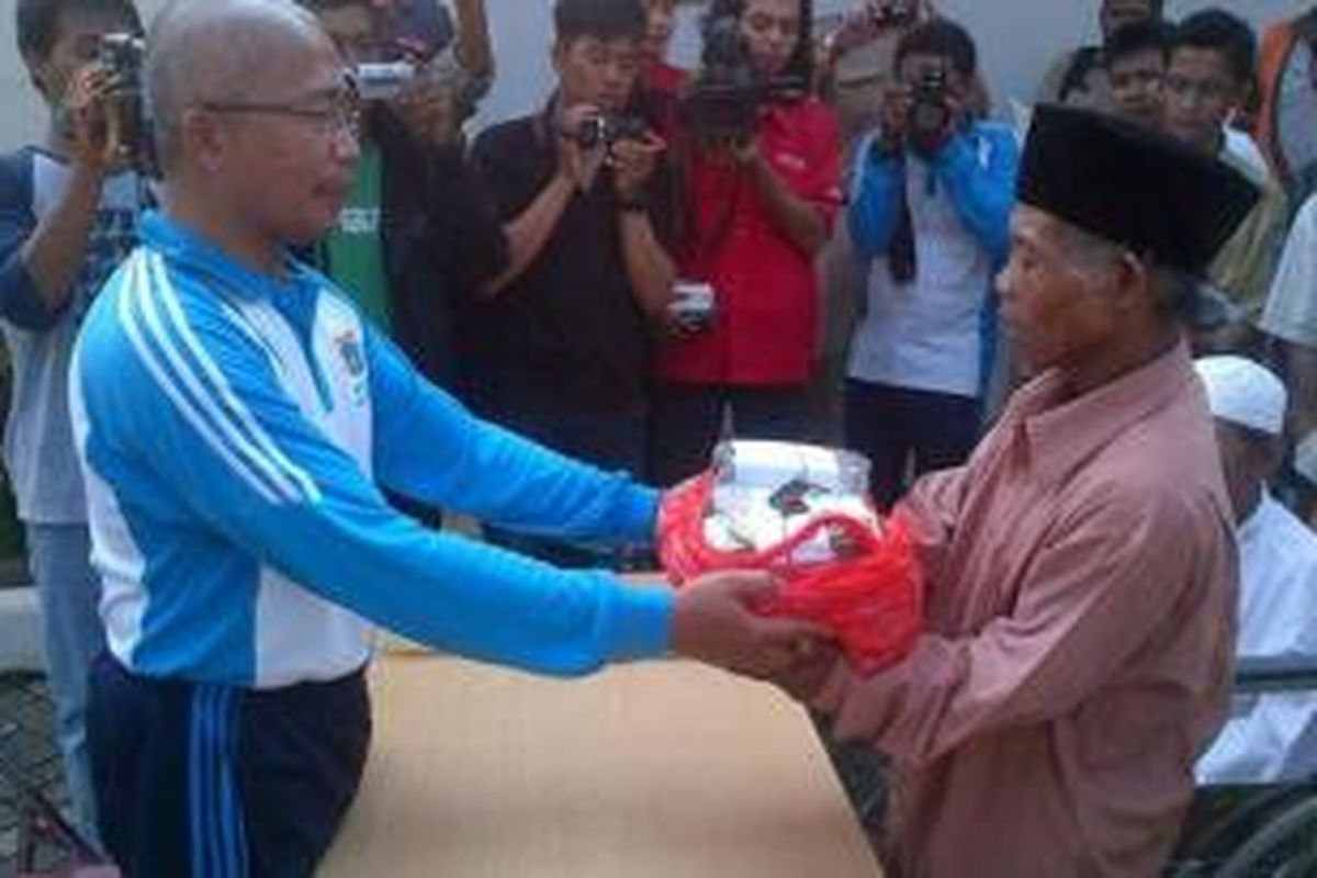 Walang bin Kilon (kanan), 54 tahun, menerima kembali uang yang dibawanya saat mengemis di Jakarta, Selasa (3/12/2013). Penyerahan dilakukan di Panti Sosial Bina Insan Bangun Daya II, Cipayung, Jakarta Timur, Selasa (3/12/2013), sebelum Walang dipulangkan ke Subang, Jawa Barat.