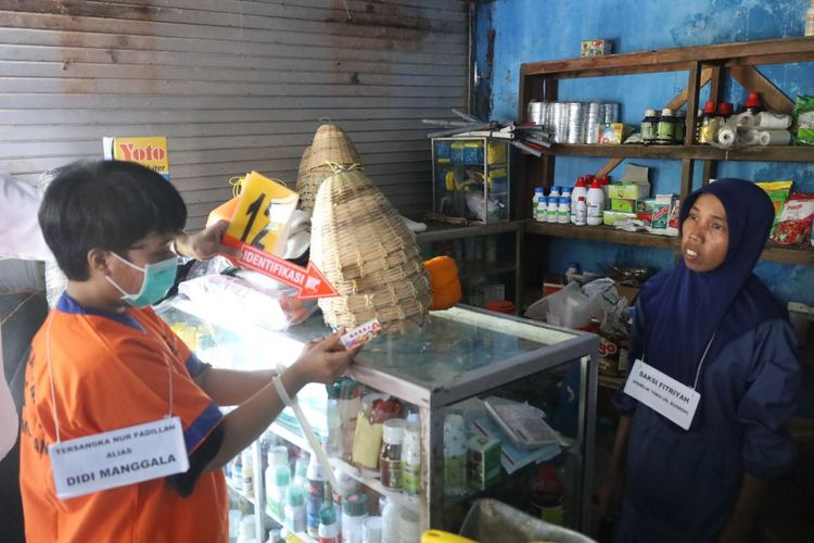 Adegan tersangka Nur Fadilah alias Didi Manggala (kiri) saat membeli racun tikus cair, dalam reka ulang kasus pembunuhan berencana yang dilakukan, Senin (6/5/2024).