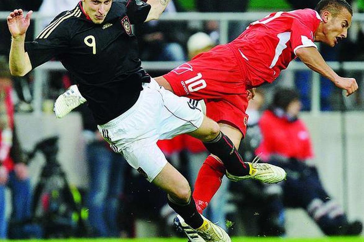 Striker Jerman, Stefan Kiessling (kiri), dan pemain Malta, Andrew Cohen, terhuyung ketika bertabrakan dalam laga persahabatan di Aachen, Jerman, Kamis (13/5). Jerman menang 3-0.