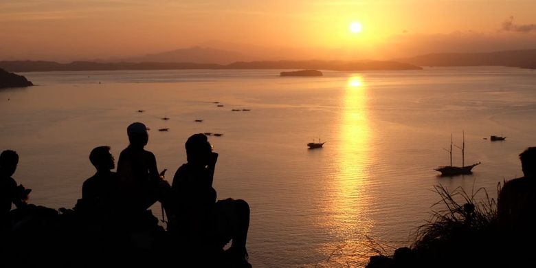 Some tourists witness sunrise from a scenic place in Pulau Badar, Labuan Bajo on Flores Island. 