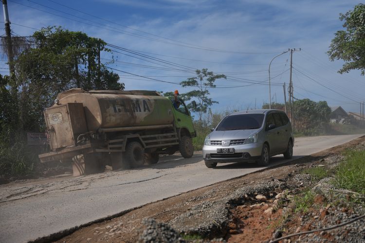 Kondisi Jalan Negara, Pemaluan, Kecamatan Sepaku, Kabupaten Penajam Paser Utara (PPU) kotor dan berdebu, terdapat ceceran adukan semen dari truk-truk peggangkut material konstruksi pembangunan Ibu Kota Nusantara (IKN), Kamis (8/2/2024).
