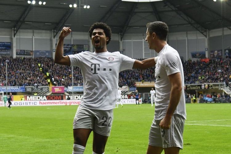 Serge Gnabry dan Robert Lewandowski merayakan gol mereka pada pertandingan SC Paderborn vs Bayern Muenchen dalam lanjutan Bundesliga, 28 September 2019. 