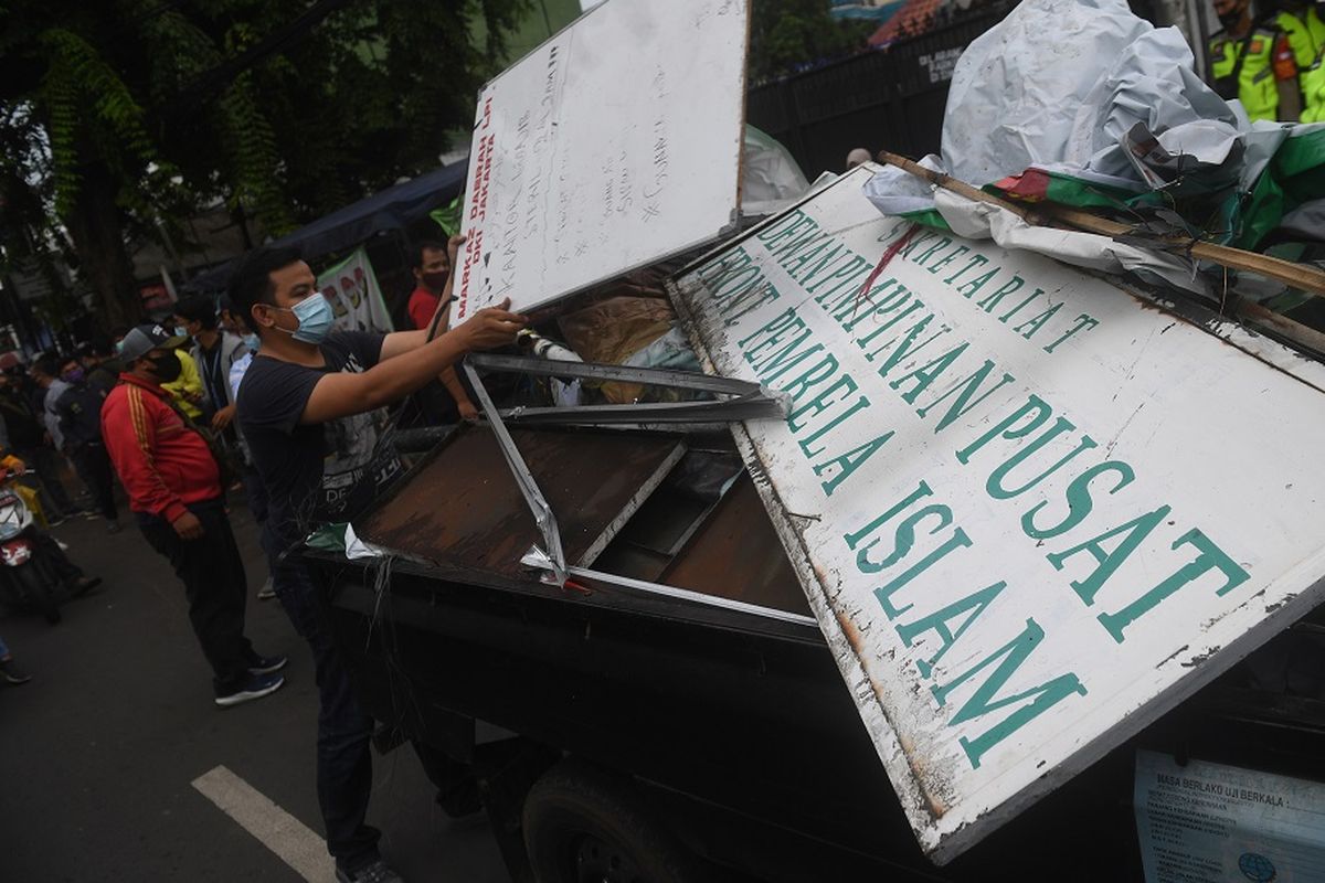 Petugas membongkar atribut-atribut saat melakukan penutupan markas  DPP Front Pembela Islam (FPI) di Petamburan, Jakarta, Rabu (30/12/2020). Polisi dan TNI menutup markas FPI setelah pemerintah memutuskan untuk membubarkan organisasi pimpinan Rizieq Shihab itu. ANTARA FOTO/Akbar Nugroho Gumay/nz