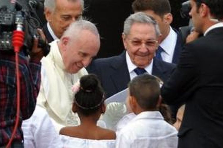 Paus Fransiskus didampingi Presiden Kuba Raul Castro saat baru mendarat di Bandara Jose Marti, Minggu (20/9/2015)