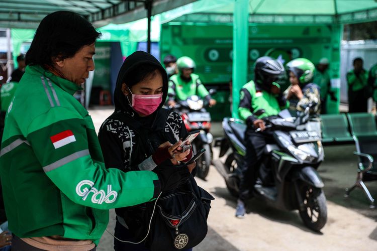 Pengemudi ojek online dengan penumpangnya berada di Kawasan Stasiun Sudirman, Jakarat Pusat, Rabu (11/3/2020). Kementerian Perhubungan (Kemenhub) resmi menaikan tarif ojek online untuk zona 2 atau wilayah Jabodetabek pada 16 Maret 2020. Kemenhub memutuskan untuk menaikan tarif batas bawah (TBB) ojol sebesar Rp 250 per kilometer (km) menjadi Rp 2.250 per km, dari sebelumnya Rp 2.000 per km.