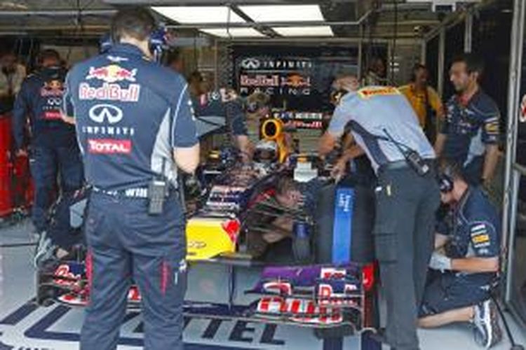 Teknisi Red Bull sedang melakukan pengecekan pada mobil pebalap Jerman, Sebastian Vettel, saat sesi latihan bebas kedua GP Jerman, di Sirkuit Hungaroring, Jumat (25/7/2013).